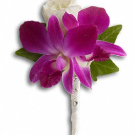 Purple and white orchid boutonniere with green leaves and a white ribbon wrap