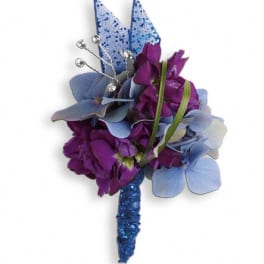 Purple and blue floral boutonniere with glittered accents