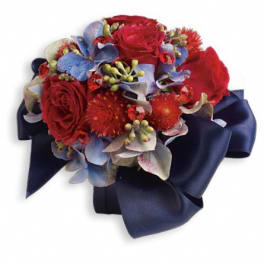 Red rose bouquet with blue flowers and a navy ribbon
