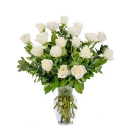 Tall arrangement of white roses in a clear glass vase