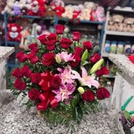 Bouquet of red roses and pink lilies with a red ribbon