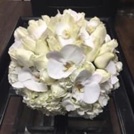 White orchid and hydrangea bouquet in a dark box
