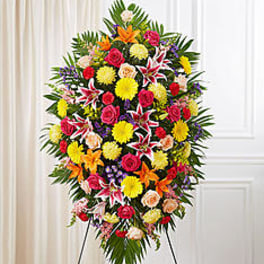 Large standing spray of mixed flowers in bright colors