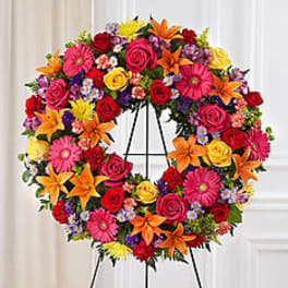 Colorful floral wreath on a black easel stand