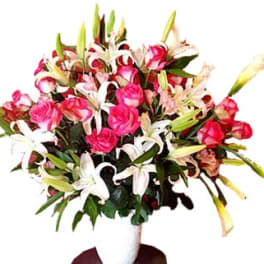 Bouquet of pink roses and white lilies in a white vase
