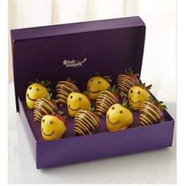 Box of chocolate-covered strawberries and smiley-face fruit