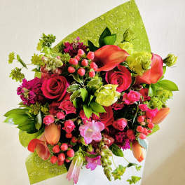 Bright mixed bouquet with red roses and orange calla lilies