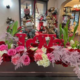 Heart-themed floral arrangement with red and pink roses and tulips