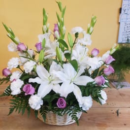 White lilies and pink roses in a wicker basket