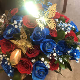 Bouquet of red and blue roses with butterfly decorations