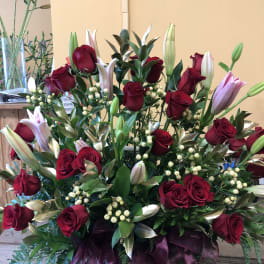 Large bouquet of red roses and pink lilies with white berries