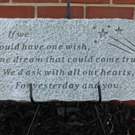 Decorative stone plaque with an engraved wish quote and shooting stars