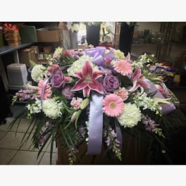 Large floral spray with pink lilies, roses, and gerbera daisies