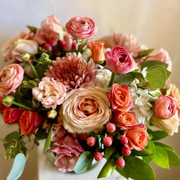 Bouquet of pink and peach flowers with roses and ranunculus