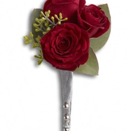 Three red rose boutonniere with silver ribbon and pearl pins