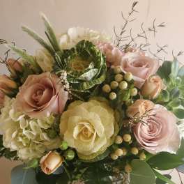 Bouquet of pale pink roses, white hydrangea, and green cabbage roses