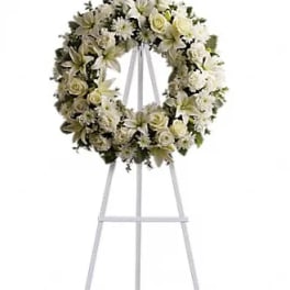 White floral funeral wreath on a standing easel