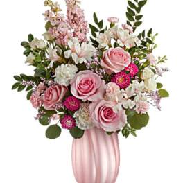 Pink roses and white flowers in a pink vase