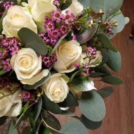 Bouquet of white roses with purple filler flowers and eucalyptus