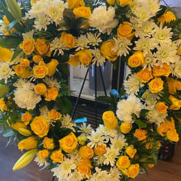 Heart-shaped floral wreath with yellow roses and white chrysanthemums