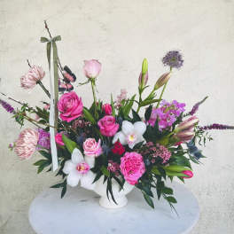 Pink and white floral arrangement in a white vase
