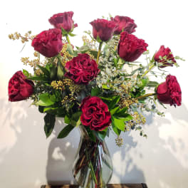 Bouquet of deep red roses in a clear glass vase