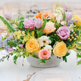 Pastel mixed flower arrangement in a white bowl vase