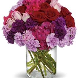 Pink and red mixed bouquet in a clear glass vase