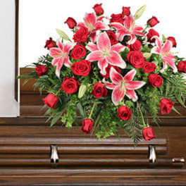 Red roses and pink lilies arranged on a casket