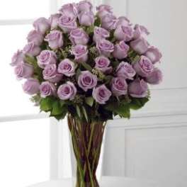 Lavender rose bouquet in a clear glass vase