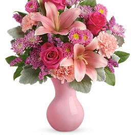 Pink lilies and roses in a pink vase