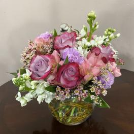 Pink and lavender rose bouquet in a glass vase