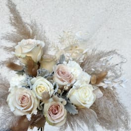 Bouquet of cream and blush roses with dried pampas grass