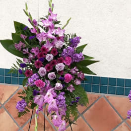 Tall purple floral standing spray on an easel