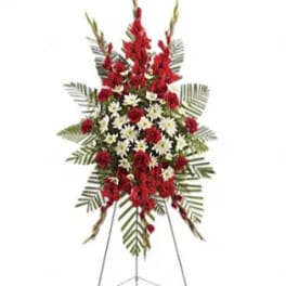 Standing floral spray with red and white flowers on an easel