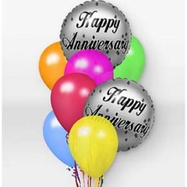 Cluster of colorful balloons with two silver "Happy Anniversary" balloons