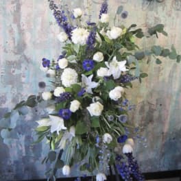 Tall white and purple floral spray on a stand