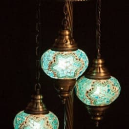 Three turquoise mosaic hanging lanterns on a bronze stand
