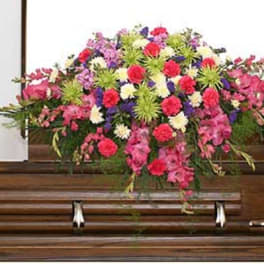 Colorful floral spray on a wooden casket