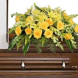 Yellow floral spray on a wooden casket
