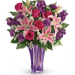 Pink lilies and roses in a purple vase