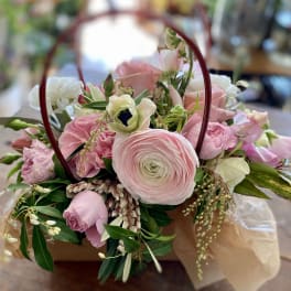 Pink and white mixed bouquet in a handled basket