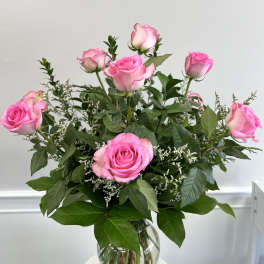 Arrangement of pink roses in a clear glass vase