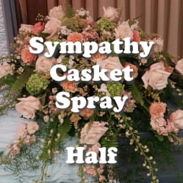 Half casket spray with peach and cream roses and carnations with soft green accents