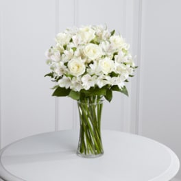 White roses and alstroemeria in a clear glass vase