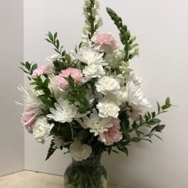 White and pink floral arrangement in a glass vase