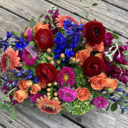Colorful mixed bouquet with red, orange, blue, and pink flowers
