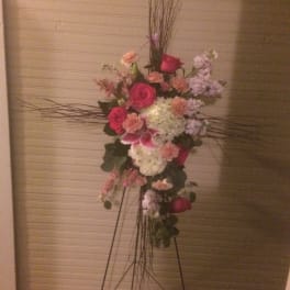 Tall floral standing arrangement with pink and white blooms on a metal easel