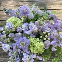 Lavender bouquet with hydrangeas, roses, and purple blooms