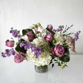 Bouquet of pink roses and white hydrangeas in a clear glass vase